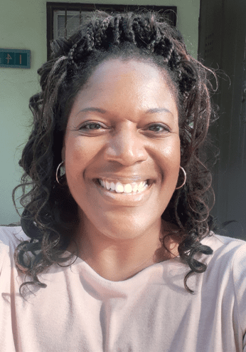 A woman with long hair and a smile.